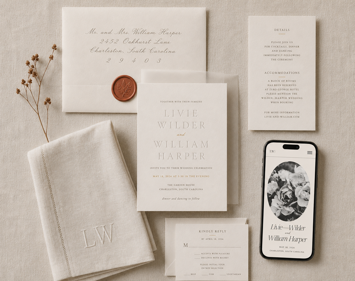 Bliss & Bone luxury wedding invitation suite flat-lay on oat silk with blind-letterpress ecru cotton invitation, gold foil accent, vellum overlay, wax-sealed envelope, and a matching wedding website shown on a phone, unifying the printed and digital visual language.